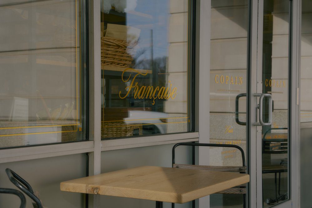 Winston-Salem — clean glass storefront with gold Française script lettering
