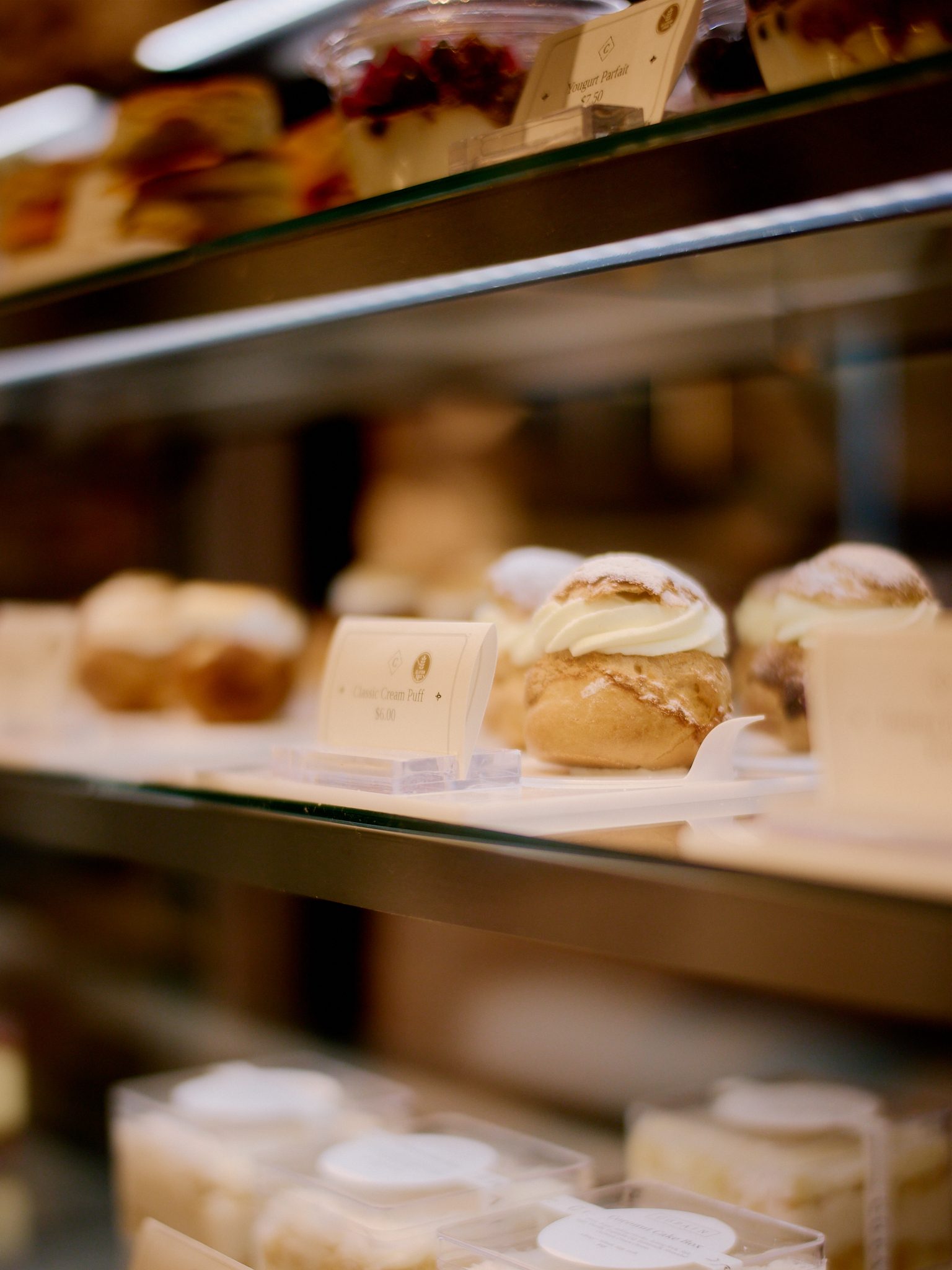 Winston-Salem bakery case — laminated pastries and breads in soft morning light