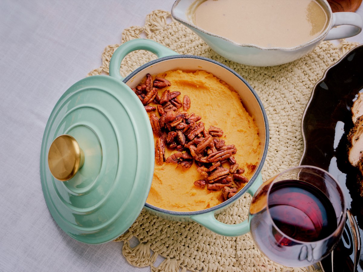 Sweet potato casserole with pecan crumble in a teal Dutch oven