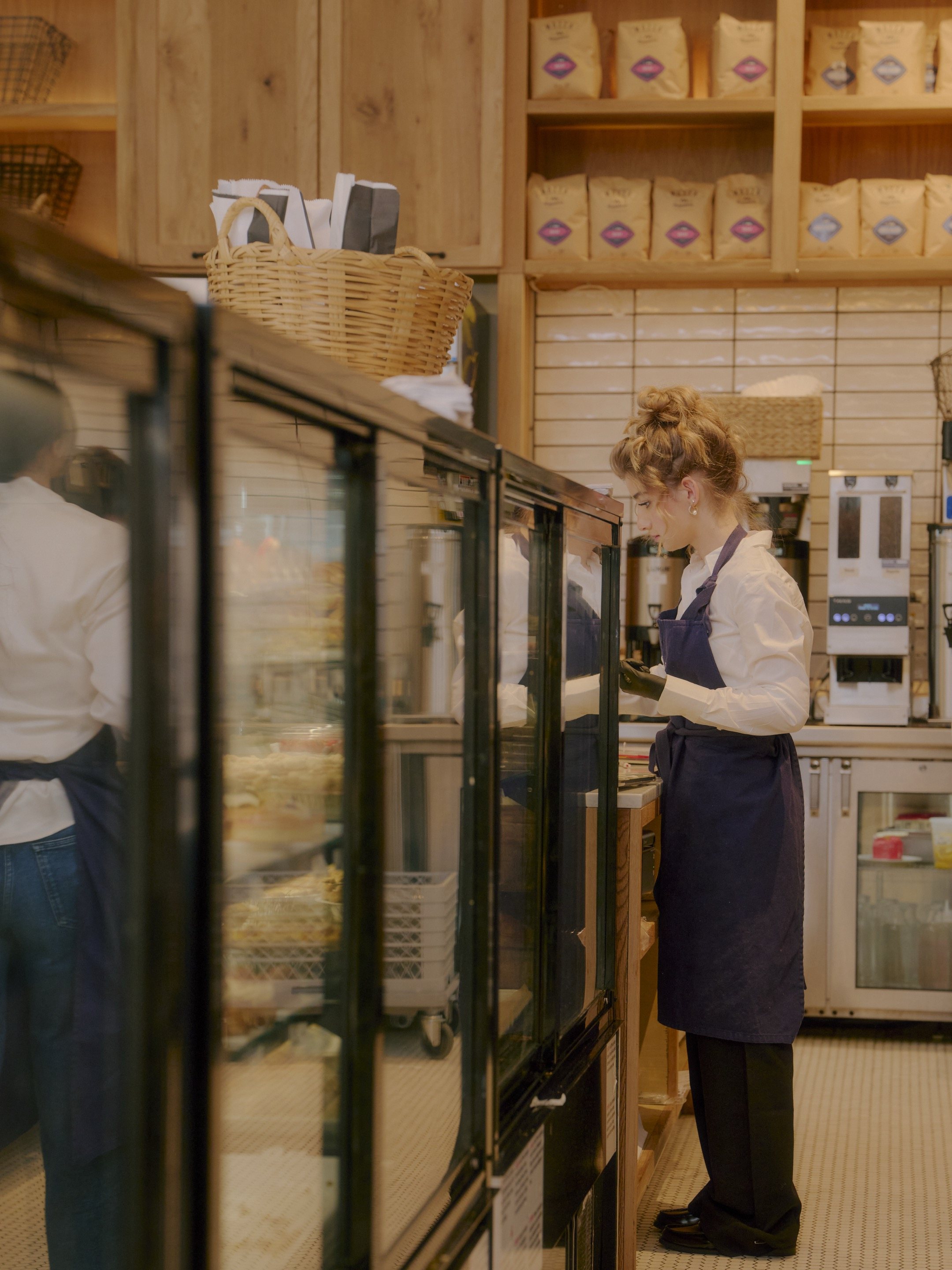 Copain employee working behind the bakery counter